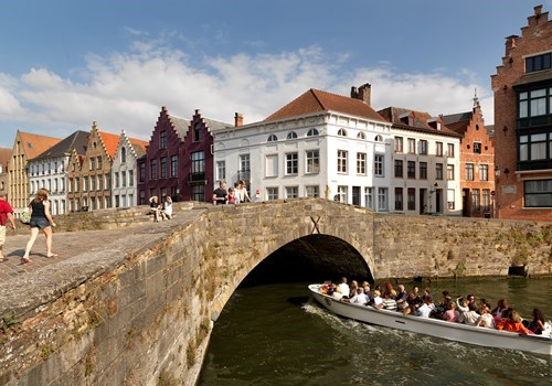 Boat passing under a bridge in Bruges, Belgium